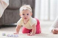 Sweet baby girl crawls on the floor